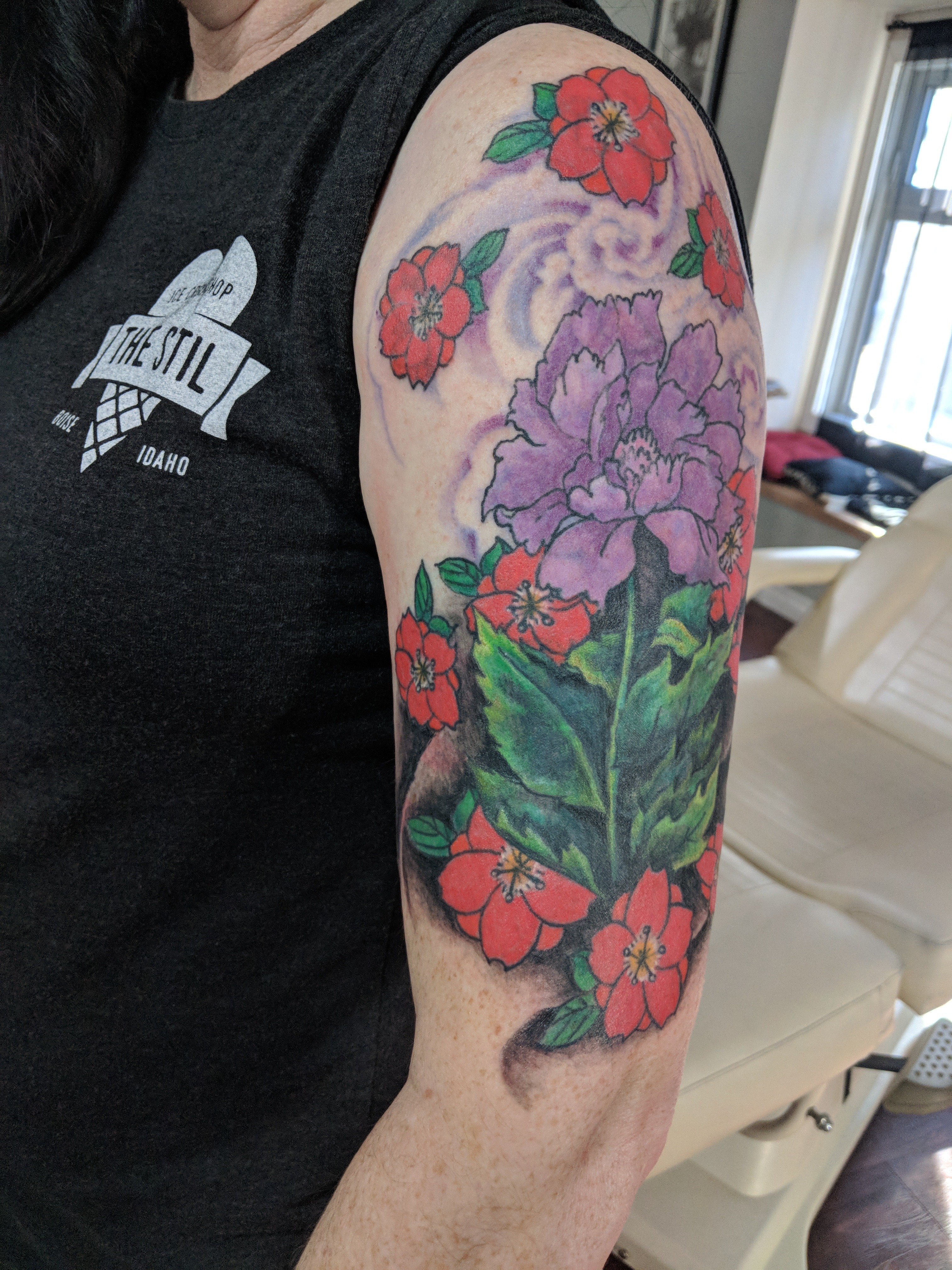 Image of a coverup floral tattoo on an upper arm