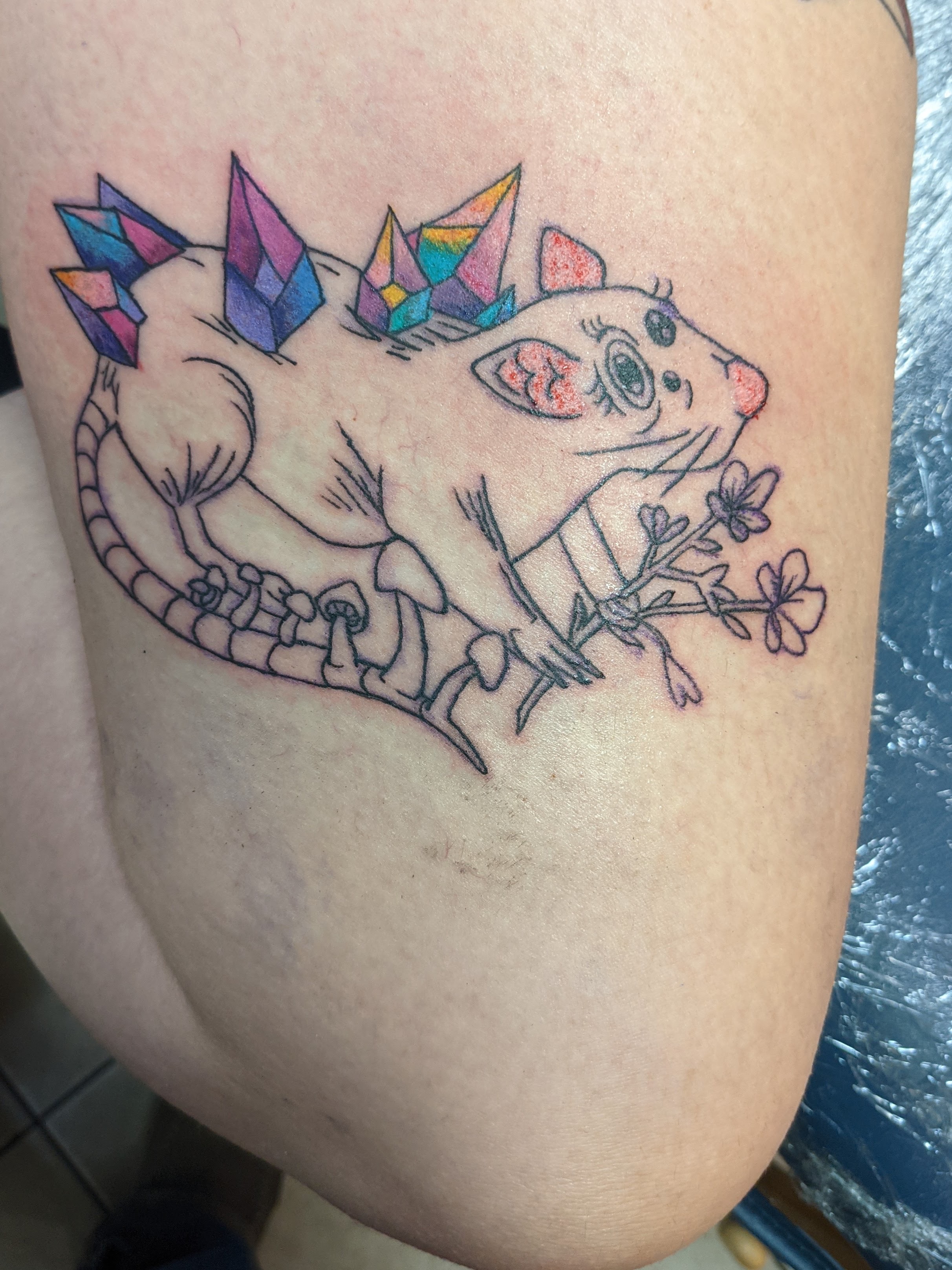 Tattoo of a Rat with Crystals, Mushrooms and Flowers on a thigh